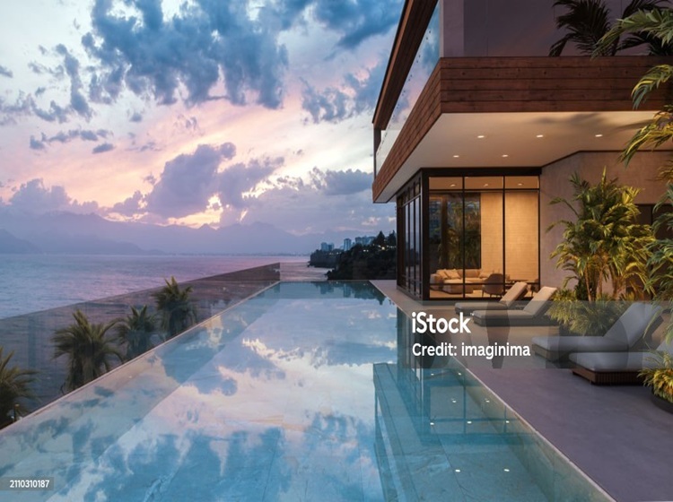 luxury modern house with swimming pool and beautiful sea view at dusk.