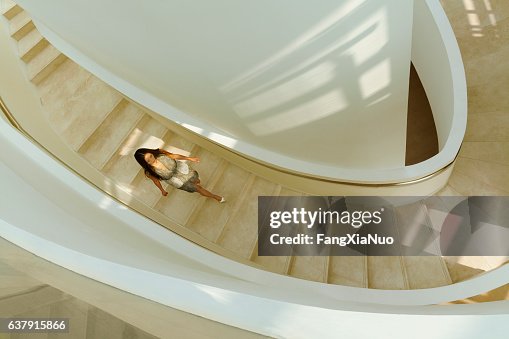 view of woman descending staircase in modern building
